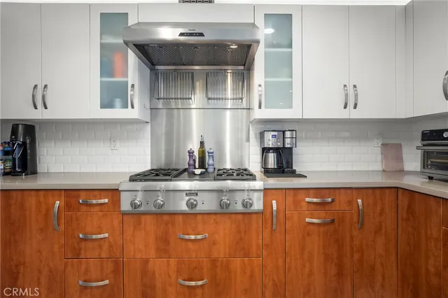 a kitchen with stainless steel appliances granite countertop a sink and cabinets