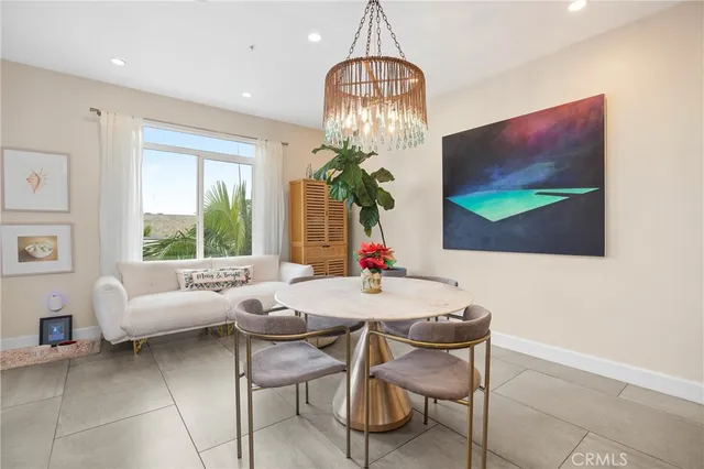 a dining room with furniture a chandelier and window