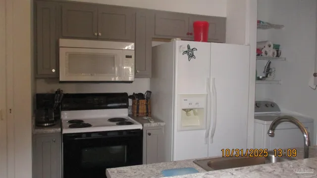 a kitchen with a refrigerator stove and cabinets