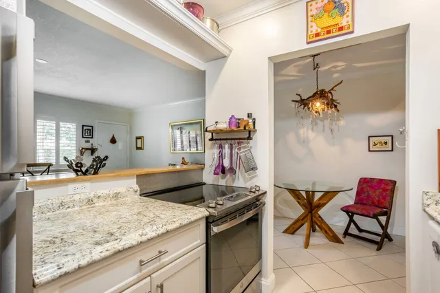 a kitchen with stainless steel appliances granite countertop a refrigerator and a stove