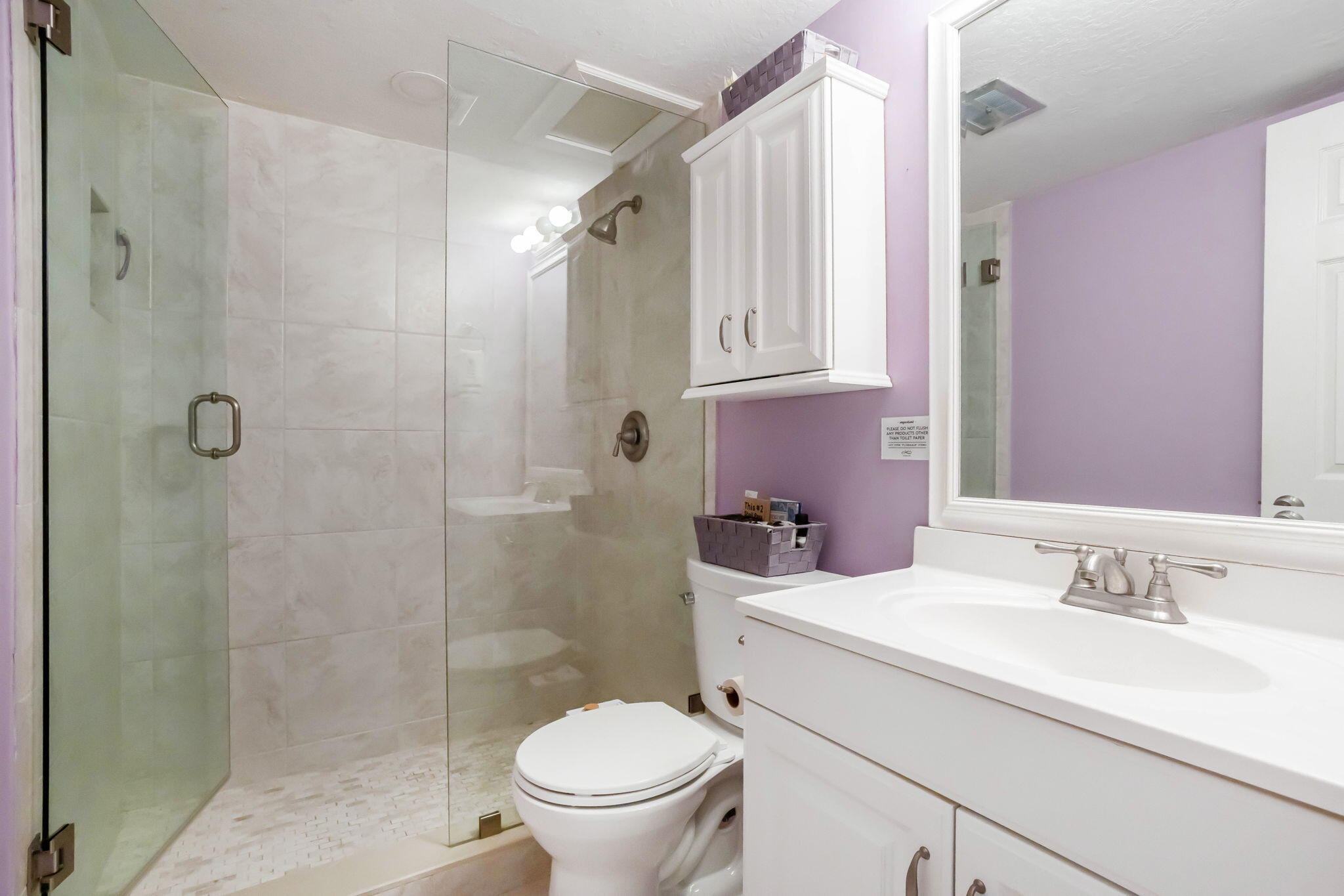 1001 Northeast 8th Avenue, Unit 112 Delray Beach, FL 33483 - Photo 17 of 25 a bathroom with a sink toilet and shower
