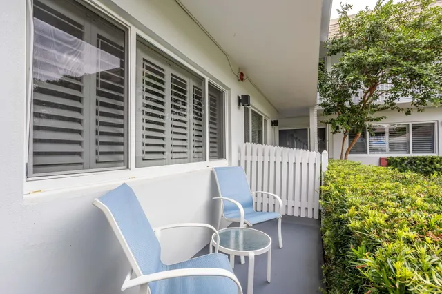 a view of balcony with wooden floor and outdoor seating