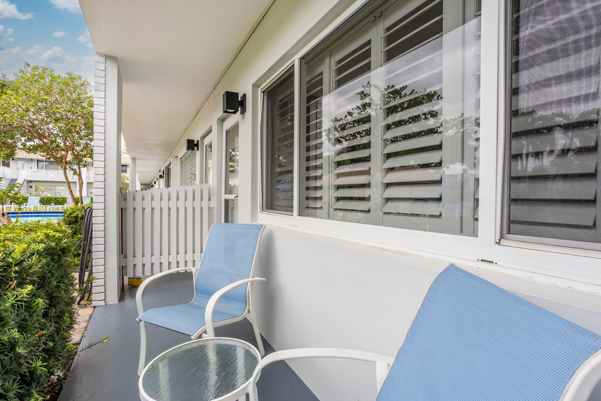 1001 Northeast 8th Avenue, Unit 112 Delray Beach, FL 33483 - Photo 7 of 25 a view of balcony with wooden floor and outdoor seating