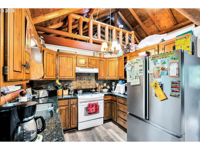 a kitchen with stainless steel appliances a sink and a refrigerator