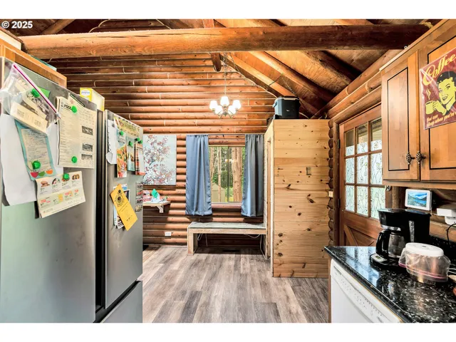 a kitchen view with stainless steel appliances granite countertop a refrigerator and a stove