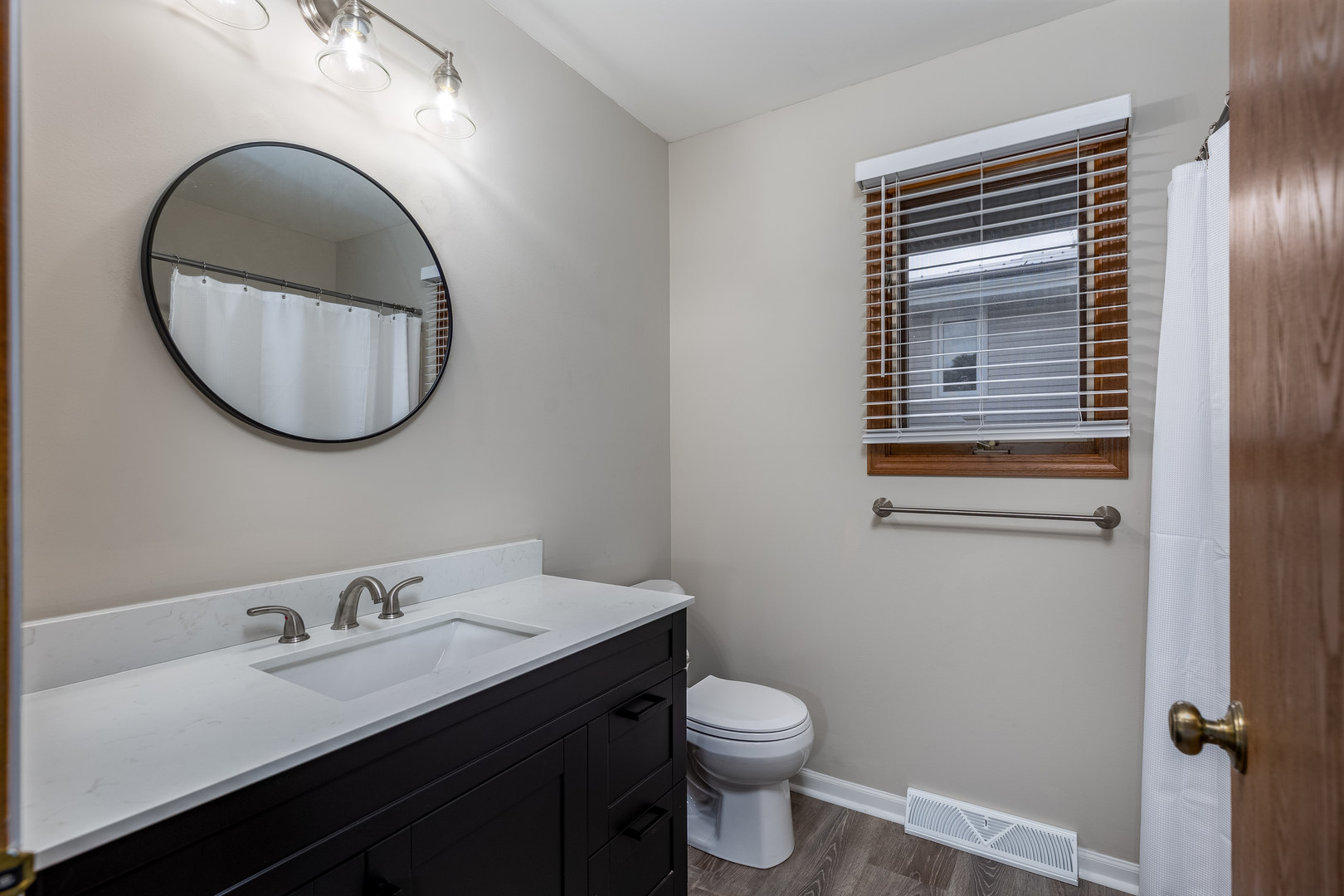 1001 4-H Road Ottawa, IL 61350 - Photo 18 of 25 a bathroom with a toilet a sink and mirror