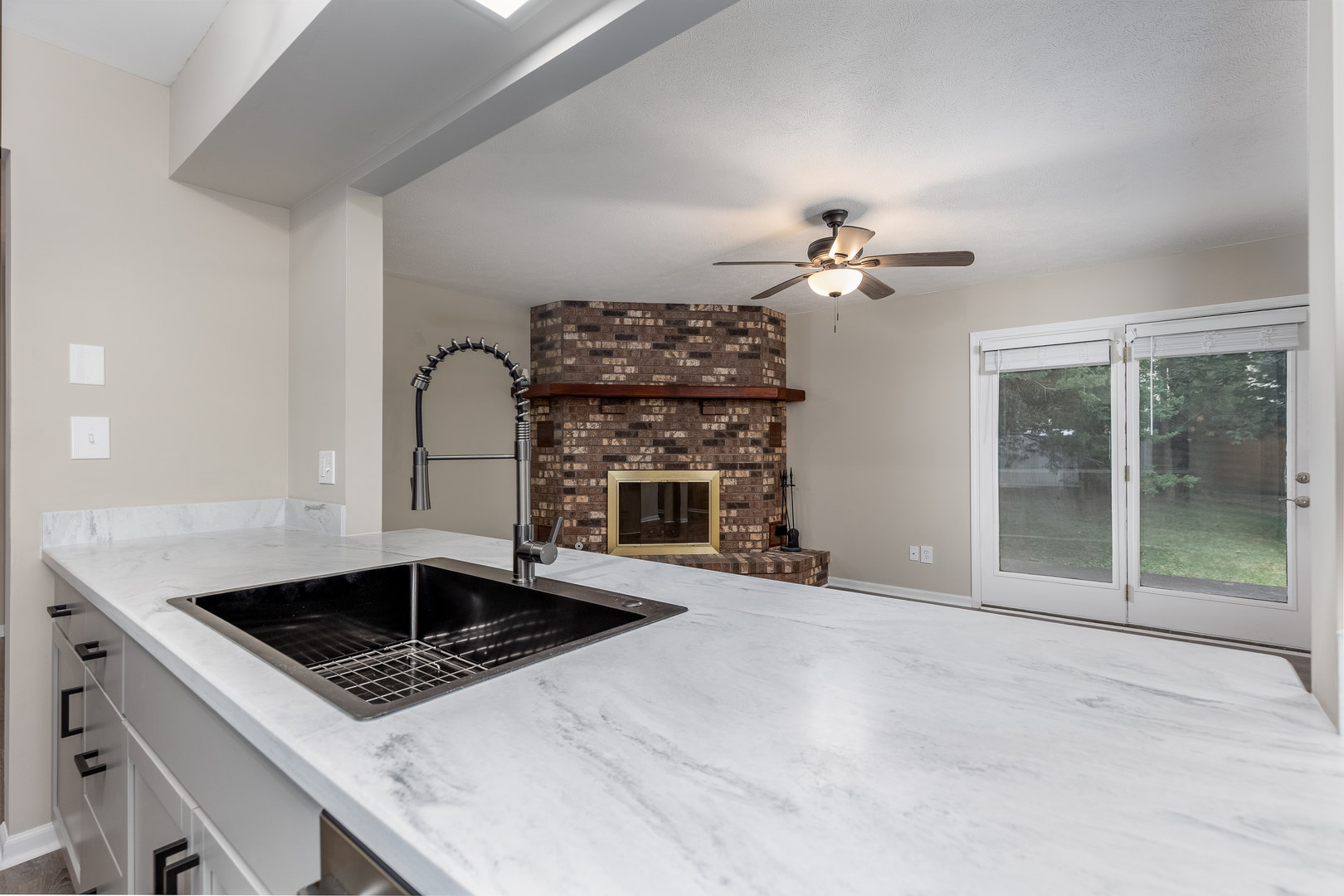1001 4-H Road Ottawa, IL 61350 - Photo 9 of 25 a kitchen with a stove a sink a chandelier and living room view