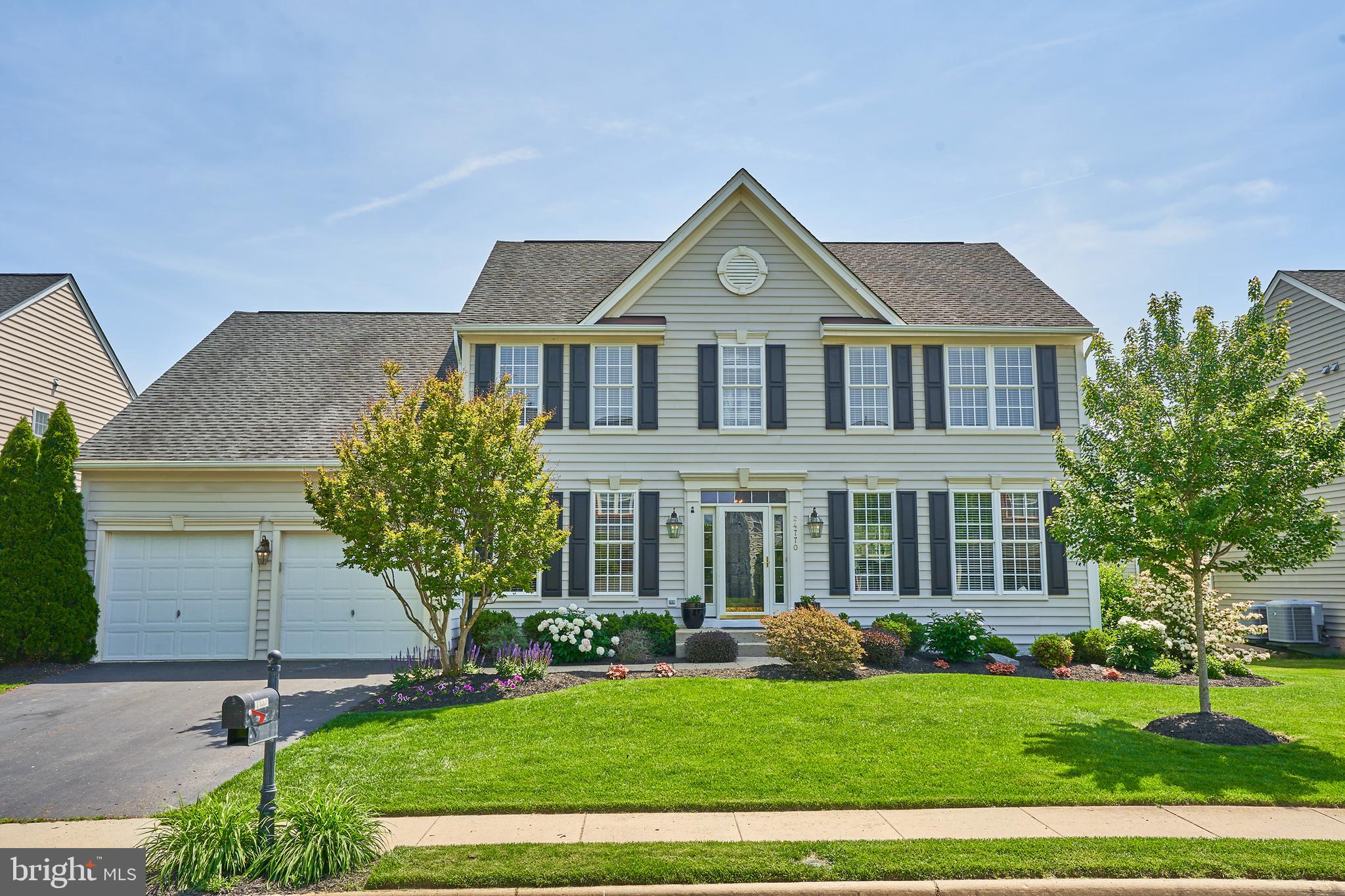 24770 Wind River Drive Chantilly, VA 20152 - Photo 1 of 50 a front view of a house with a yard