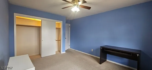 a bedroom with a bed and a ceiling fan