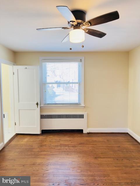 3709 Monterey Road Baltimore, MD 21218 - Photo 11 of 30 an empty room with wooden floor fan and windows
