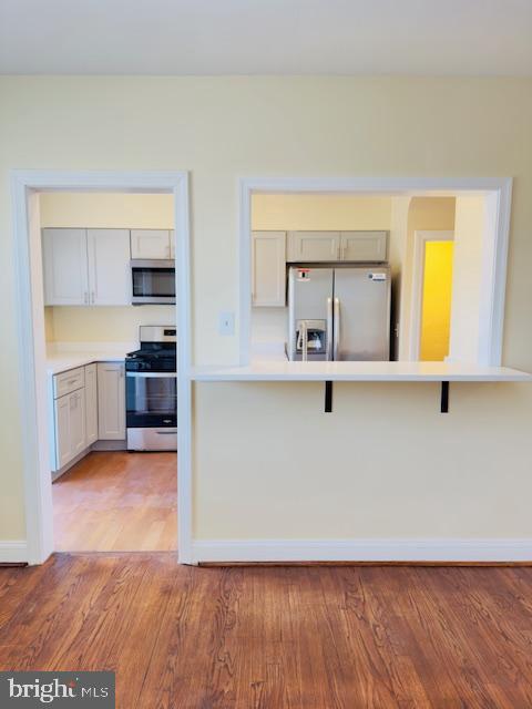 3709 Monterey Road Baltimore, MD 21218 - Photo 6 of 30 a view of a kitchen with wooden floor and a sink