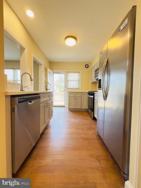 3709 Monterey Road Baltimore, MD 21218 - Photo 9 of 30 a large kitchen with stainless steel appliances granite countertop a refrigerator and a sink