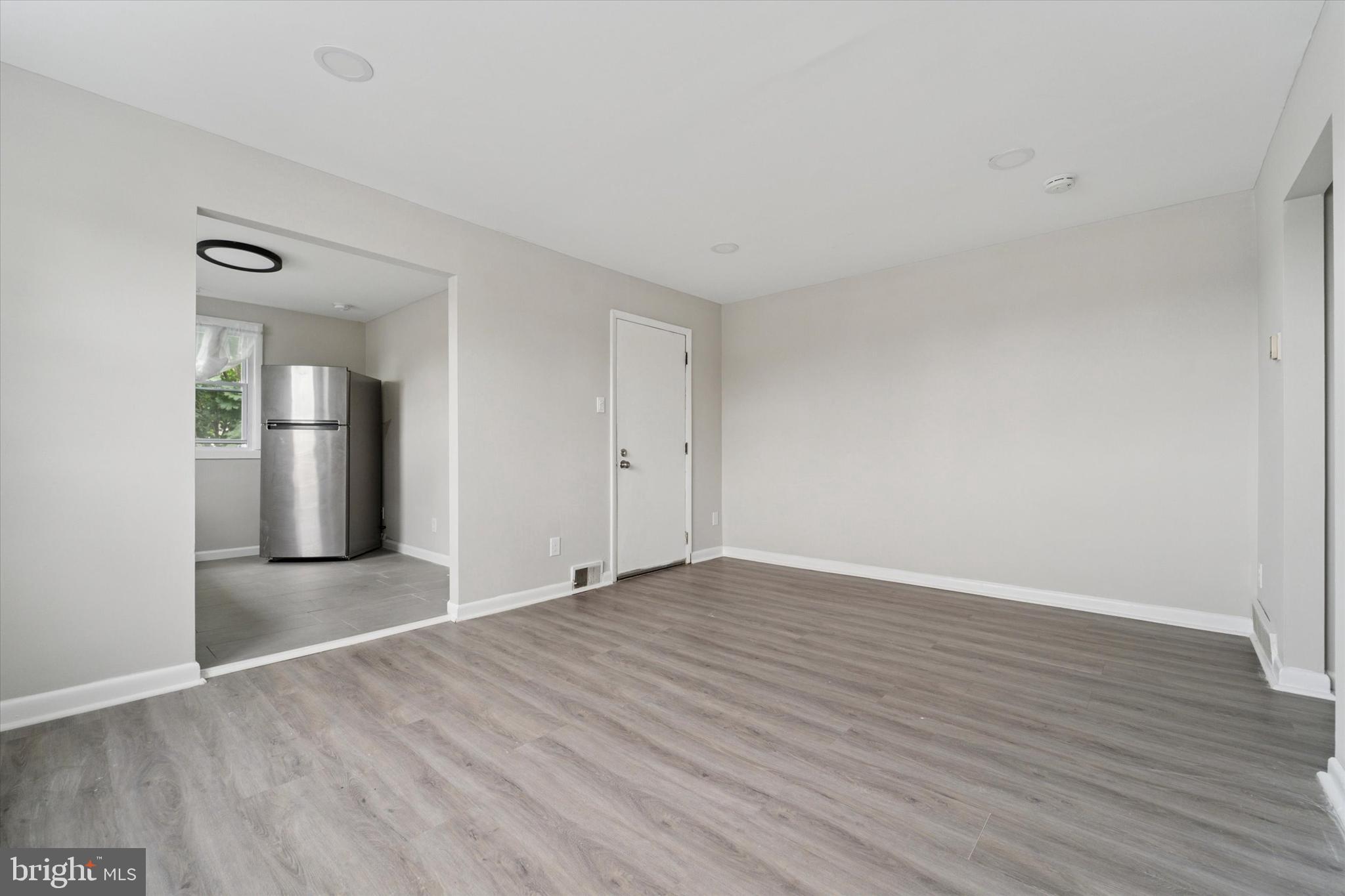 3819-3821 Garrett Road Drexel Hill, PA 19026 - Photo 12 of 24 a view of wooden floor and windows in an empty room