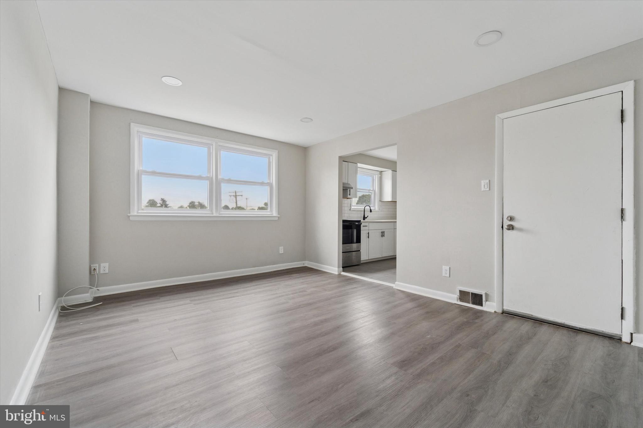 3819-3821 Garrett Road Drexel Hill, PA 19026 - Photo 14 of 24 an empty room with wooden floor cabinet and windows