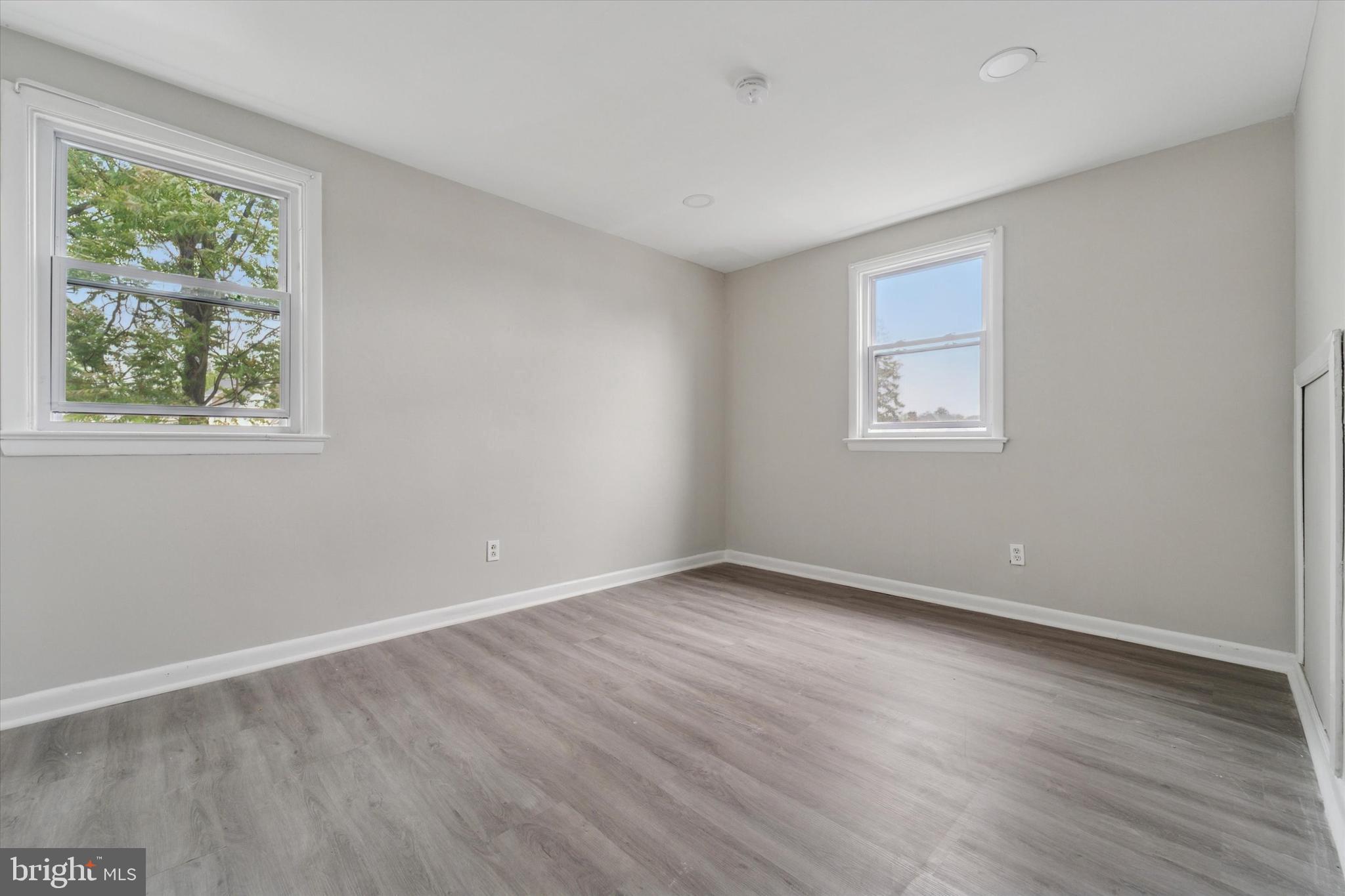3819-3821 Garrett Road Drexel Hill, PA 19026 - Photo 16 of 24 a view of an empty room with wooden floor and a window