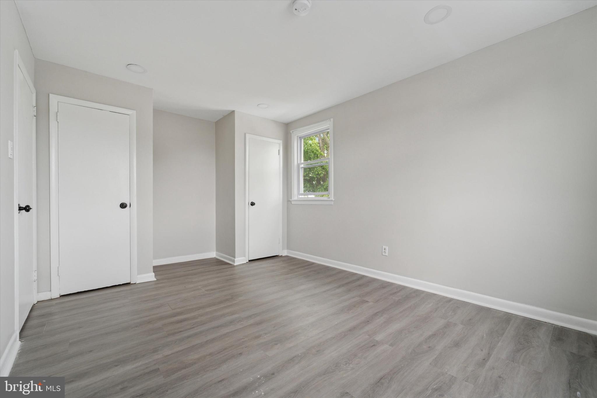 3819-3821 Garrett Road Drexel Hill, PA 19026 - Photo 19 of 24 a view of an empty room with wooden floor and a window