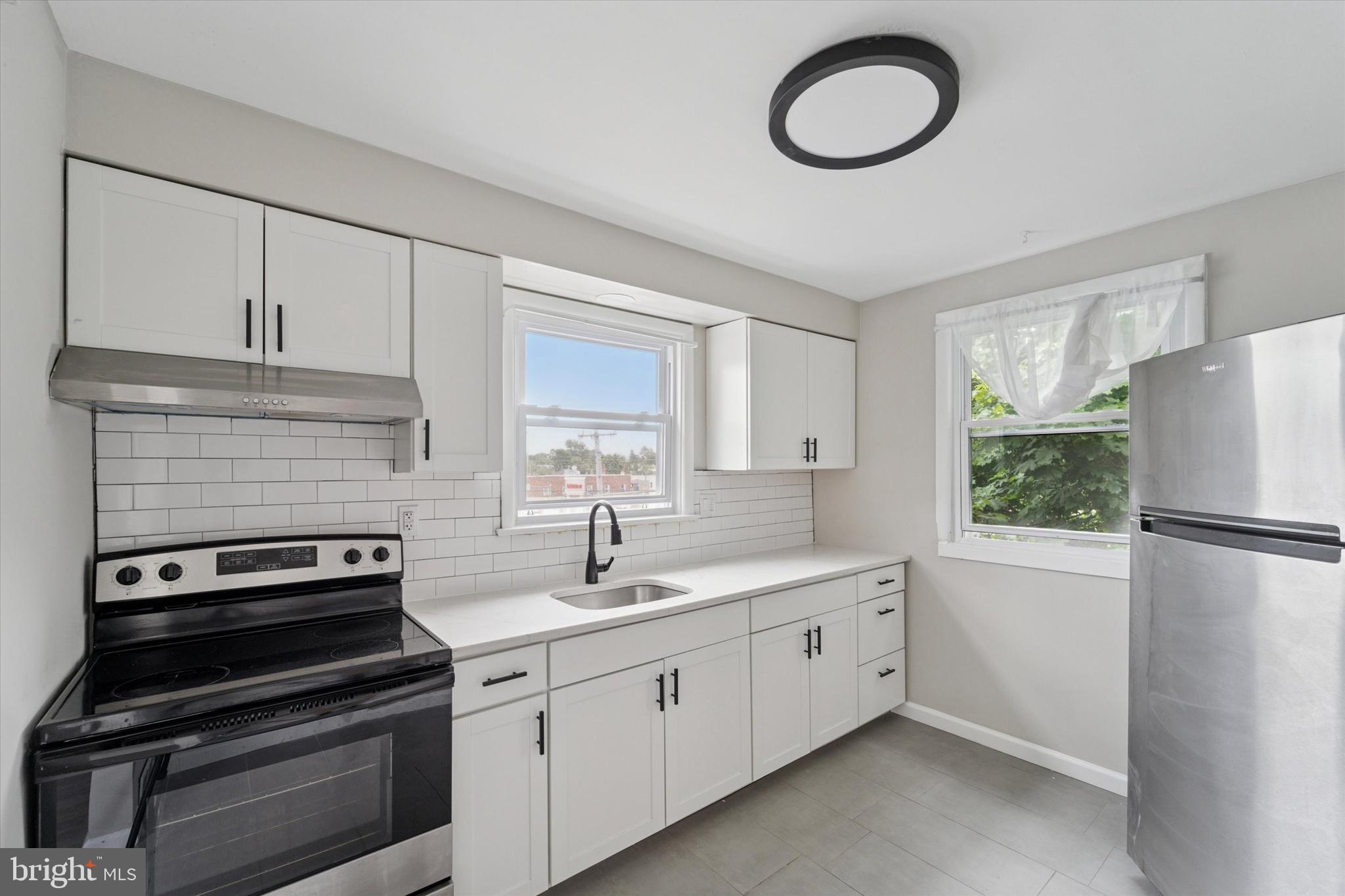 3819-3821 Garrett Road Drexel Hill, PA 19026 - Photo 8 of 24 a kitchen with appliances a sink and a window