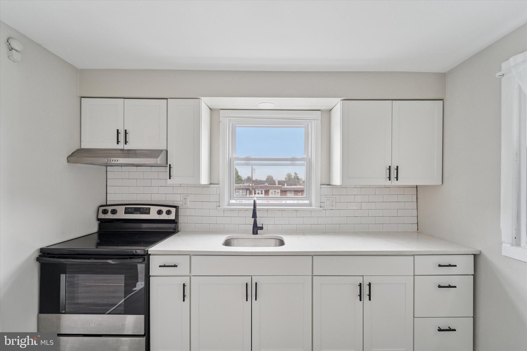 3819-3821 Garrett Road Drexel Hill, PA 19026 - Photo 10 of 24 a kitchen with a sink stove and cabinets