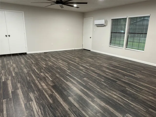 a view of a room with wooden floor and a window