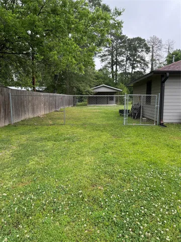 a view of a backyard with a garden and entertaining space