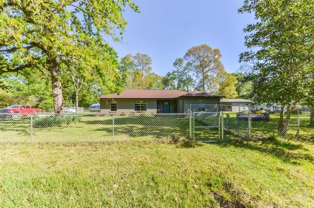 a backyard of a house with lots of green space and fountain