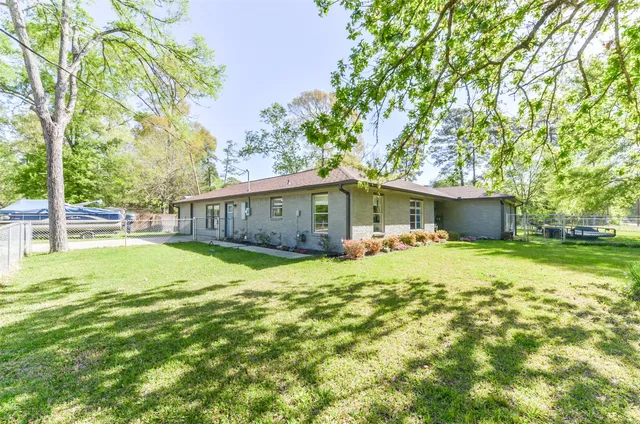 a front view of a house with a yard and trees