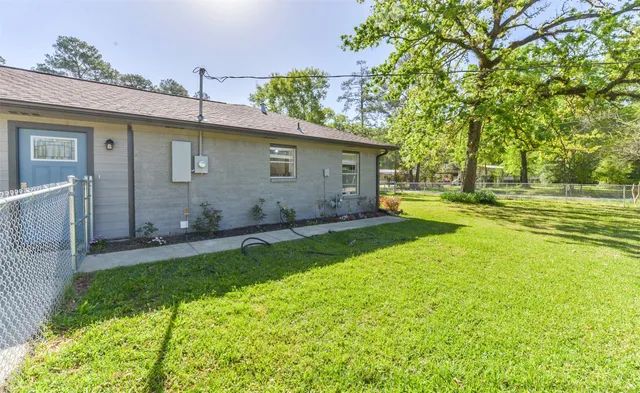 a backyard of a house with table and chairs