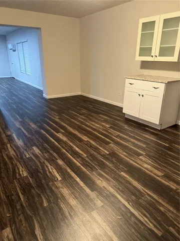 a view of a room with wooden floor and cabinet