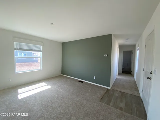 a kitchen with granite countertop a refrigerator and a stove top oven