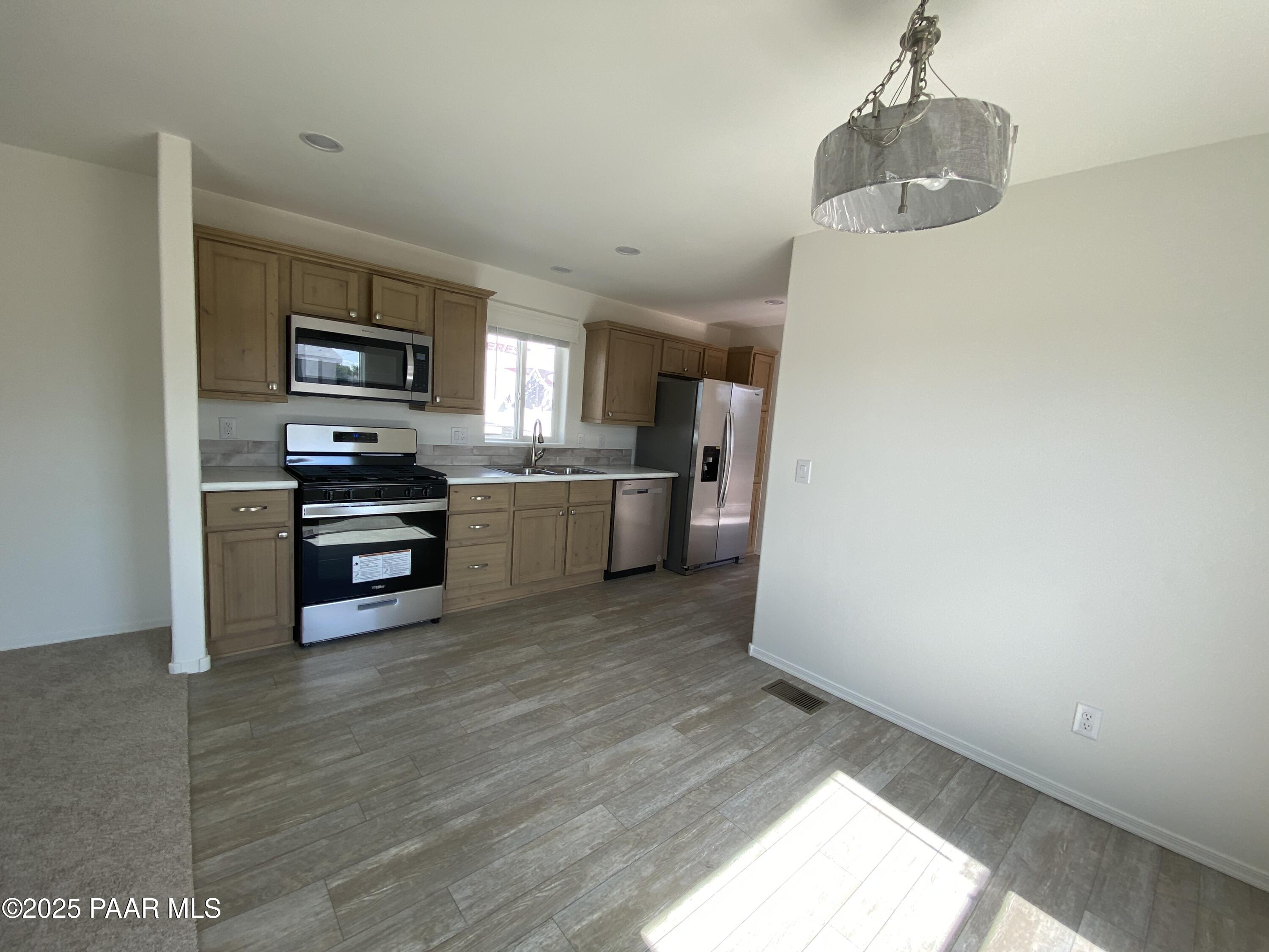 215 West Venice Way Paulden, AZ 86334 - Photo 27 of 40 a kitchen with stainless steel appliances a refrigerator and a stove top oven