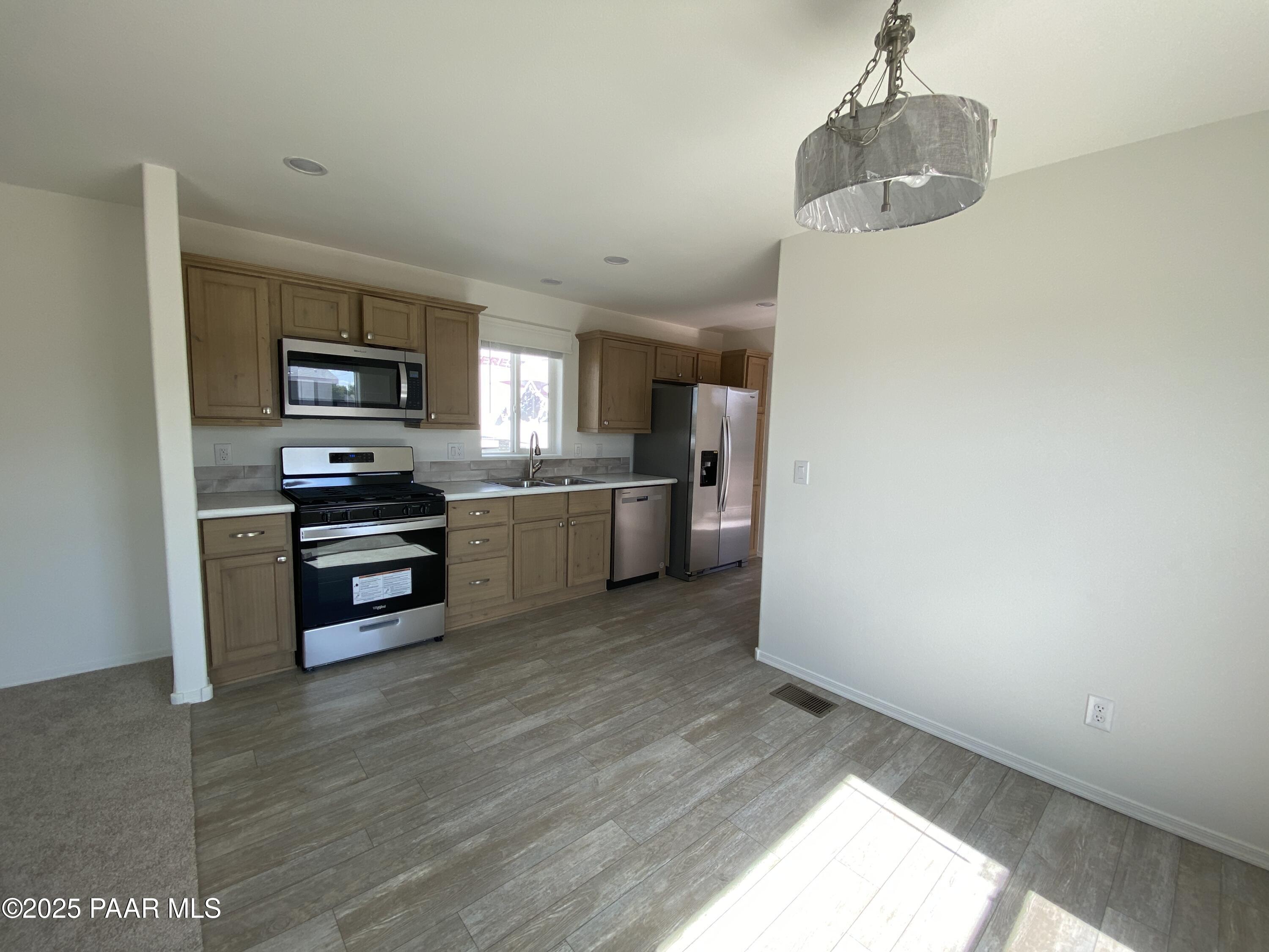 215 West Venice Way Paulden, AZ 86334 - Photo 28 of 40 a kitchen with stainless steel appliances granite countertop a refrigerator and a stove top oven