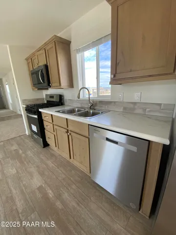 a stove top oven sitting inside of a kitchen