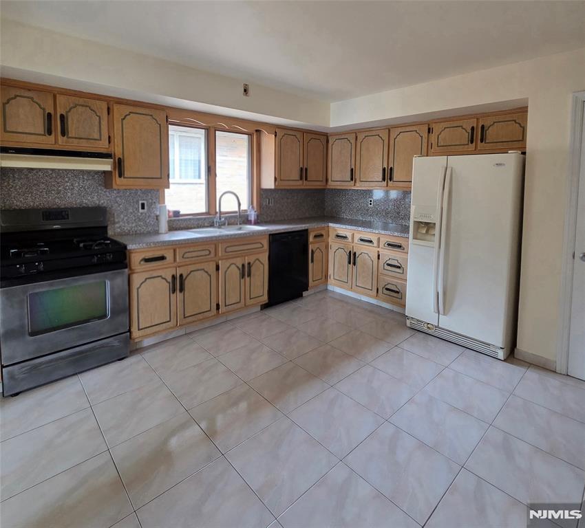 688 Day Avenue, Unit 2 Ridgefield, NJ 07657 - Photo 10 of 18 a kitchen with stainless steel appliances granite countertop a stove a sink and a refrigerator