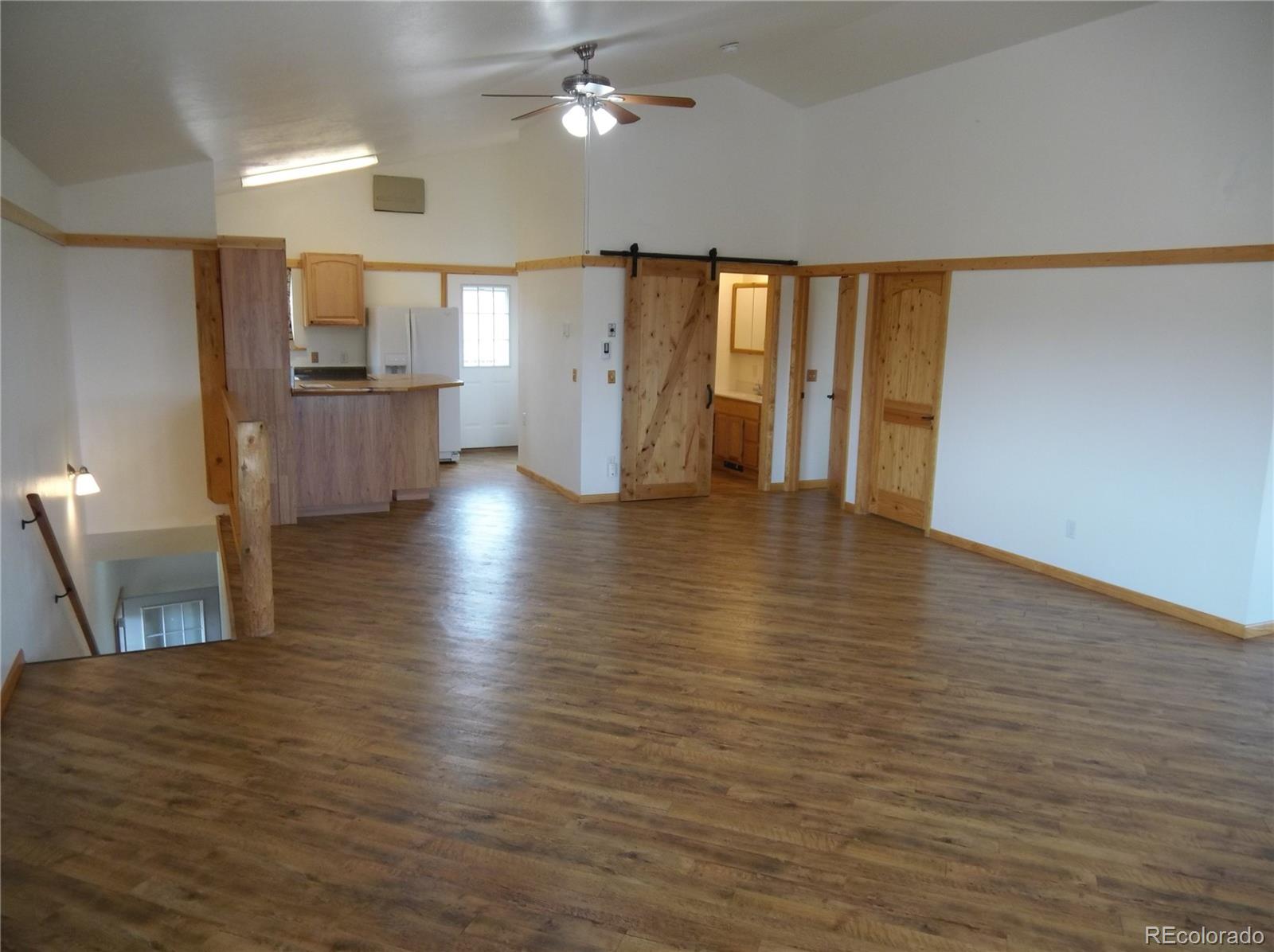 10299 Kingsview Road Austin, CO 81410 - Photo 1 of 40 a view of an empty room with window and wooden floor