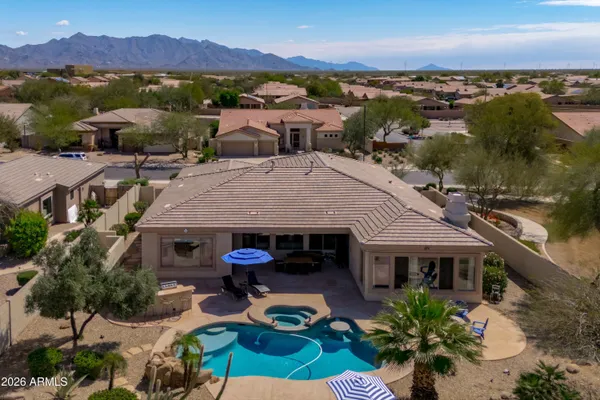 an aerial view of a house with a garden and lake view