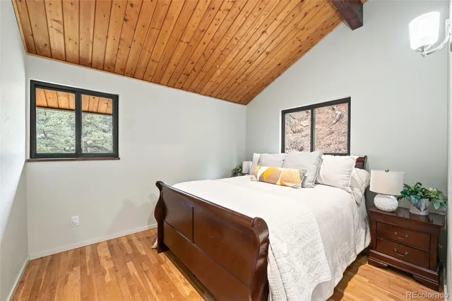 a bed sitting in a bedroom next to a window