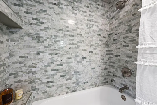 a bathroom with a bathtub and a shower