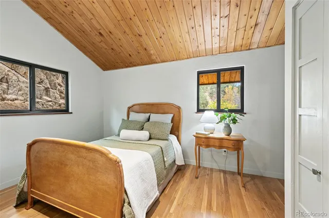 a bedroom with a bed and windows