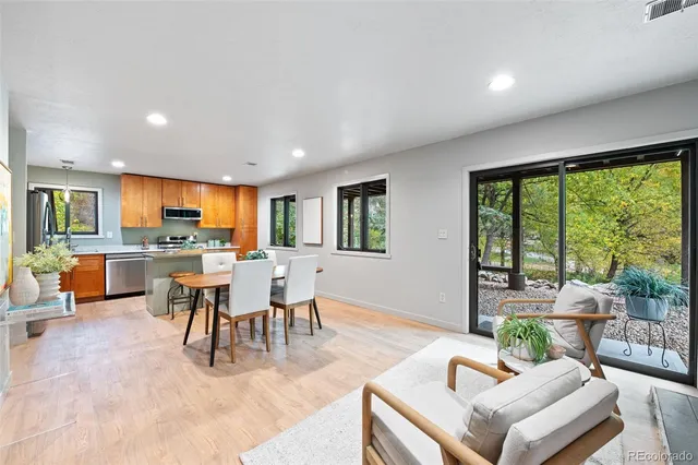 a living room with furniture a fireplace and a floor to ceiling window