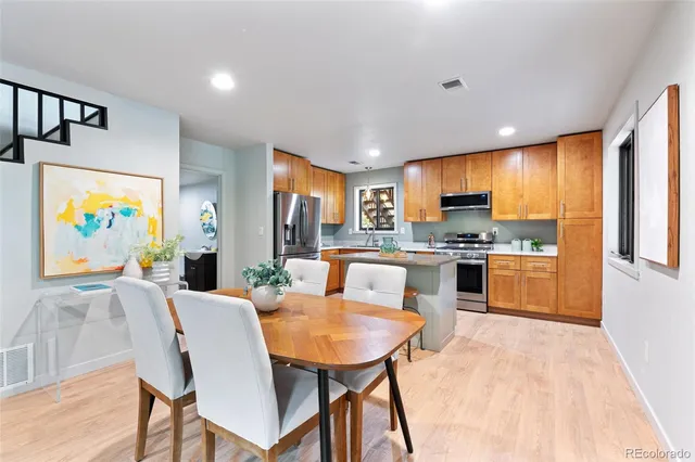 a kitchen with a table and chairs in it