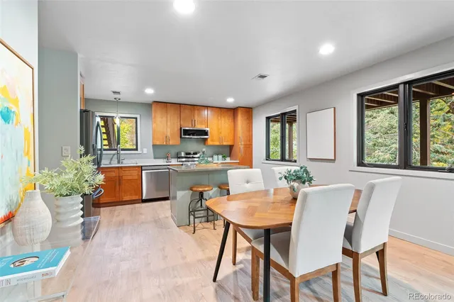 a kitchen with stainless steel appliances granite countertop wooden cabinets a stove top oven a sink and dishwasher