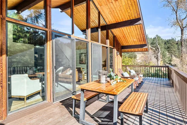 an outdoor sitting area with furniture and wooden floor