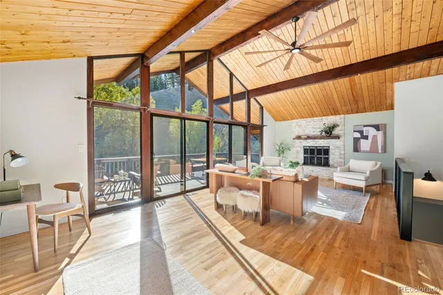 a living room with furniture a fireplace and a table