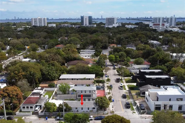 an aerial view of a house with garden and plants