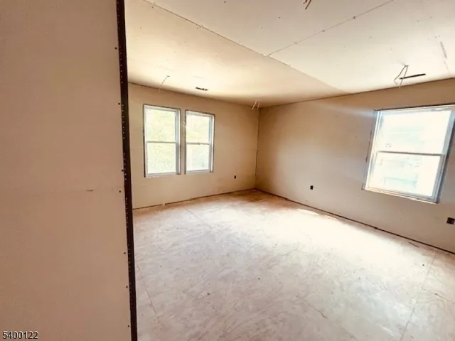 an empty room with a windows and closet