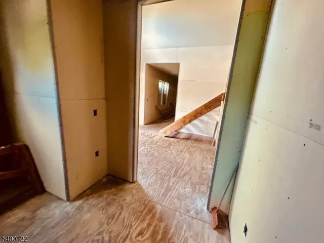 a view of a hallway view with wooden floor and staircase