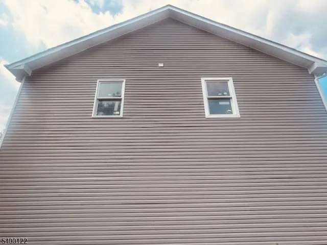 a front view of a house with white walls
