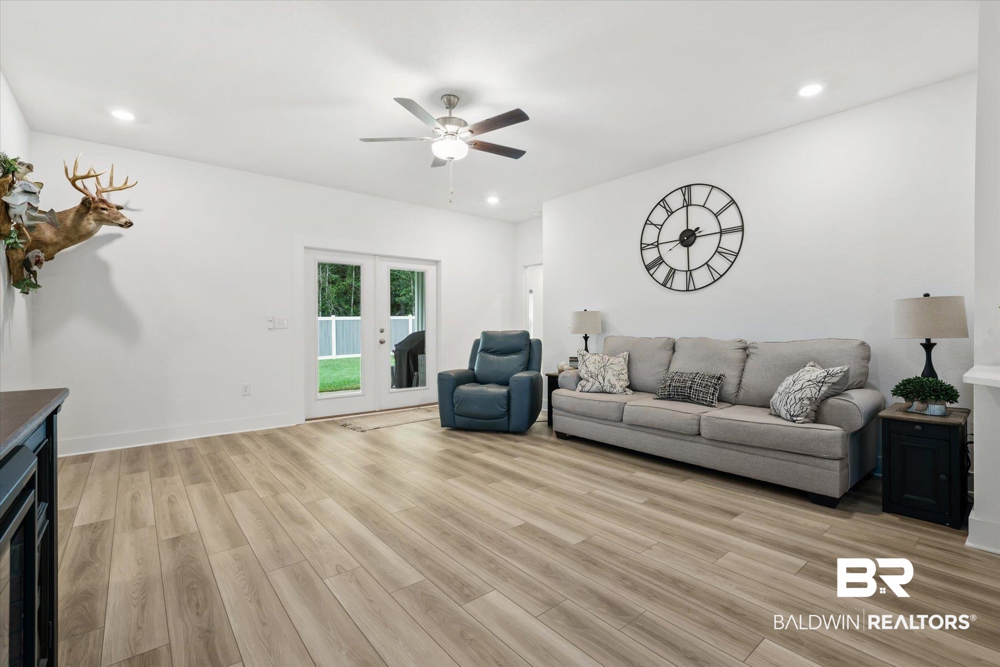 263 Bronze Street Fairhope, AL 36532 - Photo 3 of 47 Unfurnished living room featuring french doors, ceiling fan, and light hardwood / wood-style floors
