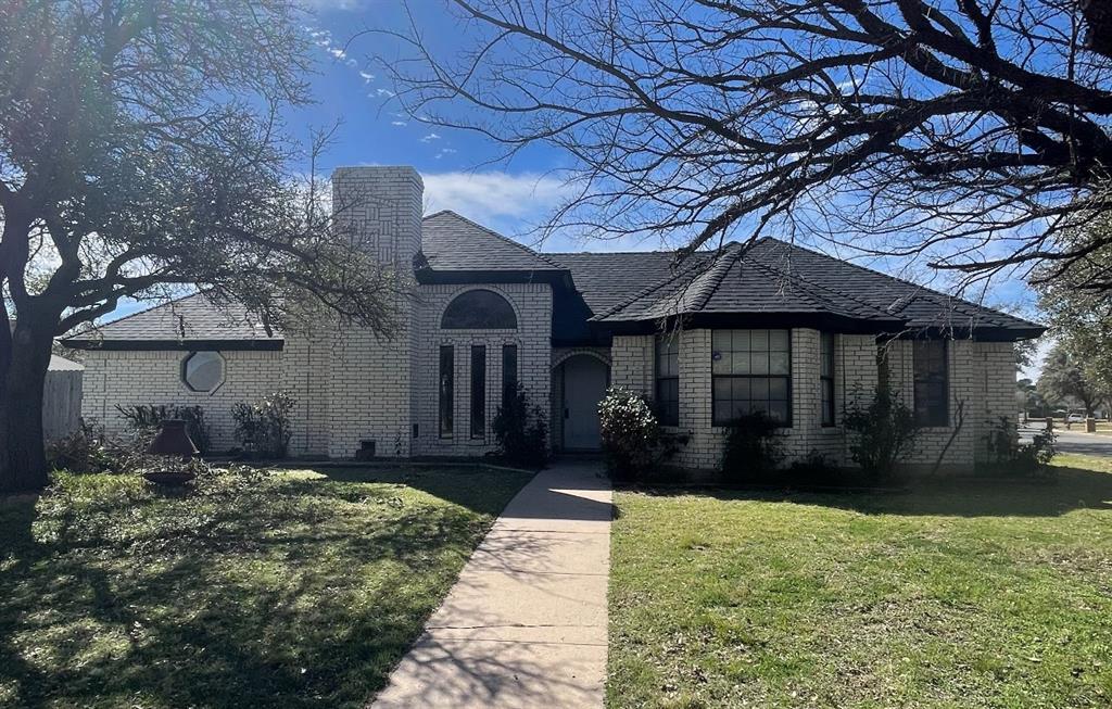 3165 Beacon Hill Road Abilene, TX 79601 - Photo 1 of 1 a front view of a house with a yard and a garden