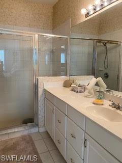 7832 Meridan Court Naples, FL 34104 - Photo 13 of 18 a bathroom with a granite countertop sink and a mirror